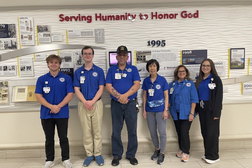 Blue Bird volunteers at the Methodist Hospital history wall